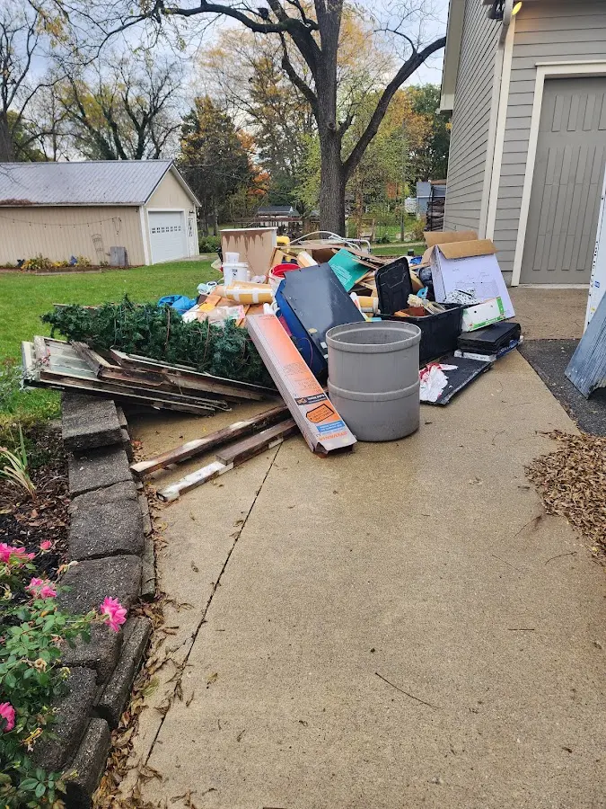 Dumpster being loaded with debris for 12 Yard Dumpster Rental in New Franklin